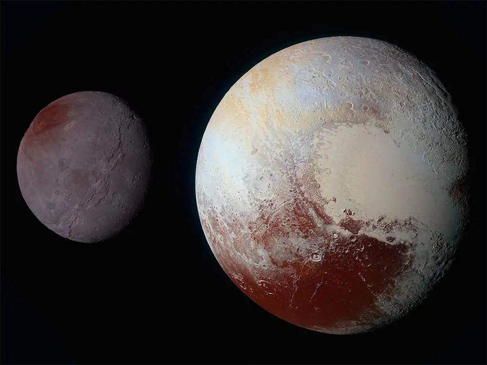 Dwarf planet Pluto (right) and its moon Charon (left) in a processed image taken by NASA's New Horizons spacecraft in 2015.